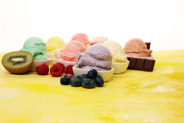 Various of ice cream flavor whit fresh blueberry, strawberry, kiwi, lemon, vanilla setup on rustic background . Summer and Sweet cold ice cream