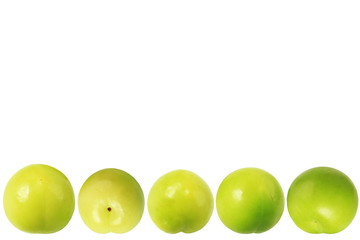 Green plums isolated on white background. Place for text. Close-up. Top view.