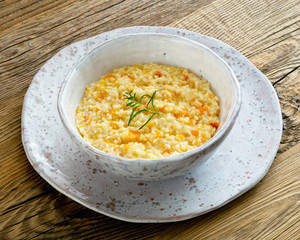 millet porridge with pumpkin decorated with fried rosemary 