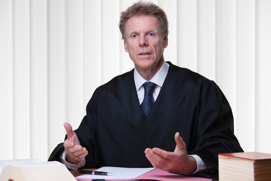 Judge or lawyer at his desk in a bright courtroom