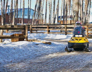 winter ride on a yellow snowmobile