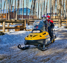 ride a yellow snowmobile