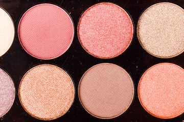 set of pastel eyeshadows isolated on rose background