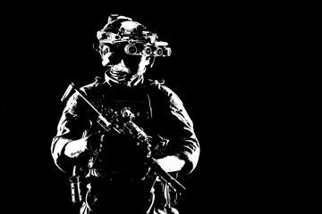 Fototapeta na wymiar Army elite soldier with hidden behind mask and glasses face, in full tactical ammunition, equipped night vision device, radio headset, looking aside, armed short barrel rifle studio contour shot