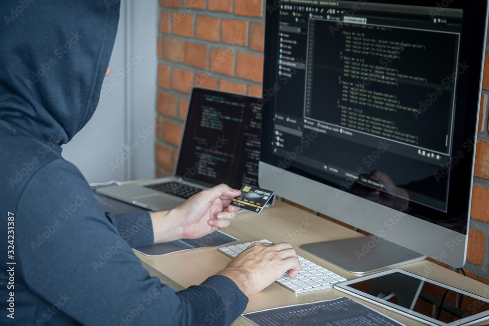 Aufkleber Computer hacker or cyber attack concept, Dangerous hooded hacker using multiple computers typing bad data into online system the access with a virus to infect steal information