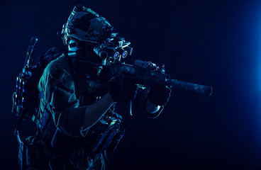 Army special operations soldier, commando fighter in full tactical ammunition, helmet with radio...