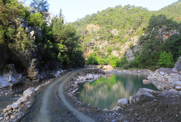 road near small lake in mountains