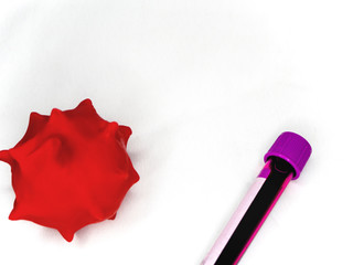 a red balloon depicting a virus and a test tube with tests on a white tissue background