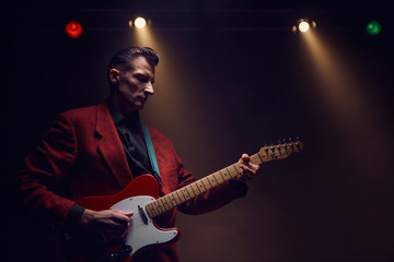 Obraz premium A guitarist perform on stage.