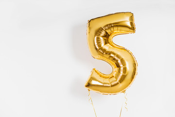 number, 5 (five) Golden or yellow ball on a white background with place for text. discounts and...