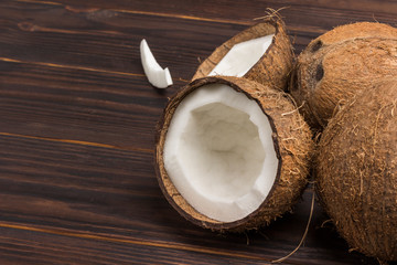 Coconut, chopped in half coconut on dark wooden background