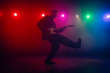 A guitarist perform on stage.