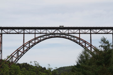 Fototapeta na wymiar Old railway bridge over a river