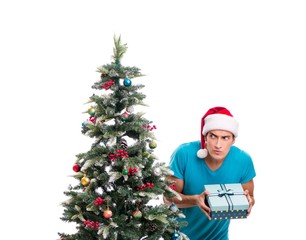 Young man decorating christmas tree isolated on white