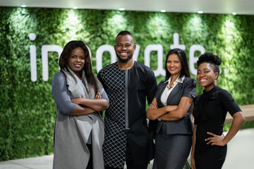 Smiling group of African businesspeople standing in a modern office