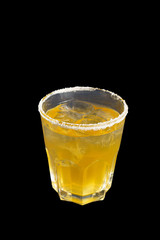 A yellow transparent cocktail in a low glass with ice cubes, with the taste of apricot, pineapple with sugar, Side view, Isolated black background, Drink for the menu restaurant, bar, cafe