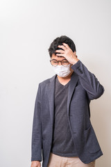 Asian man wearing surgical mask to prevent flu disease Coronavirus