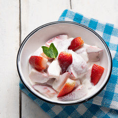 Strawberries and cream dessert on white background