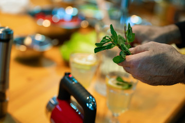 mint for making Mojito in kitchen in your hands