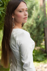 Portrait of beautiful young girl in summer garden.