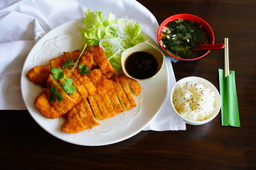 A plate of sliced fried chicken katsu at a Japanese restaurant