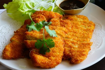 A plate of sliced fried chicken katsu at a Japanese restaurant