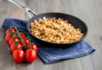 Couscous with vegetables, light healthy dietary vegan dish on a wooden table