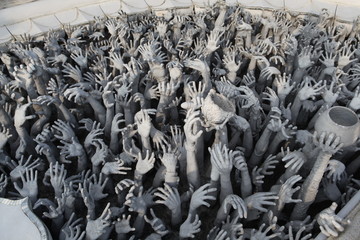 Hands of people pulled with entreaty. Wat Rong Khun (White Temple) in Chiang Rai city, Thailand....