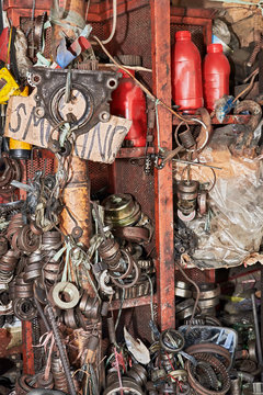 Close-up of a messy pile of old used rusty bearings and other car parts stuffed in cabinets in a auto junk shop in Iloilo City, Philippines, Asia