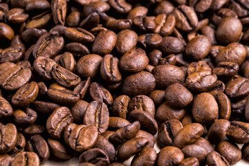 Bright brown roasted coffee beans background.