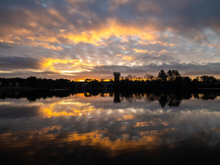 Fototapeta na wymiar Winter late sunrise at small lake in New Jersey countryside