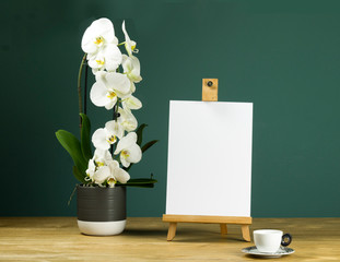 Orchid and easel for artists on an aquamarine background