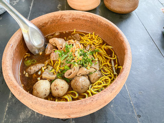 Top view Beef noodles in a clay bowl Top with meat and meat ball. For eating as lunch