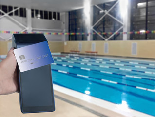 Payment purchase subscription, membership to the pool. Modern payment blue terminal and card.