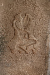 Fototapeta na wymiar detailed picture of old war, dance, mural, inscription on stone wall in religous angkor wat temple, shiva, hindu, god
