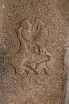 detailed picture of old war, dance, mural, inscription on stone wall in religous angkor wat temple, shiva, hindu, god