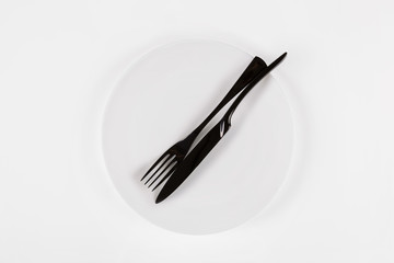 White ceramic round plate isolated on white. Finished food concept.