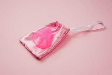 Personal vaginal bowl on a pink pouch on a pink background.