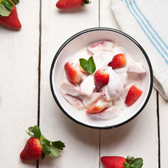 Strawberries and cream dessert on white background