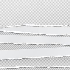 Torn, ripped pieces of horizontal squaredwhite paper with soft shadow are on grey background for text. Vector illustration