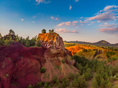 Beautiful landscape of the remains of an old sleeping volcano crater with red clay and vibrant colors, Racos, Brasov County, Transylvania, Romania