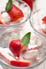 Strawberries and cream dessert on white background