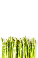 Asparagus steams frame on white background top-down copy space