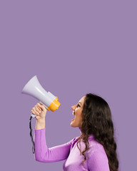 Woman shouting in megaphone and copy space
