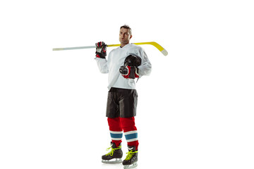 Winner. Young male hockey player with the stick on ice court and white background. Sportsman wearing equipment and helmet practicing. Concept of sport, healthy lifestyle, motion, movement, action.