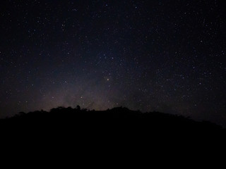Fototapeta na wymiar beautiful night sky from milky way galaxy with stars and meteor over mountain at national park, Thailand on February 2020