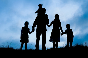 happy family by the sea on nature silhouette background