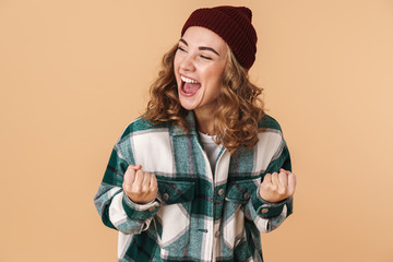 Photo of nice joyful woman laughing and making winner gesture