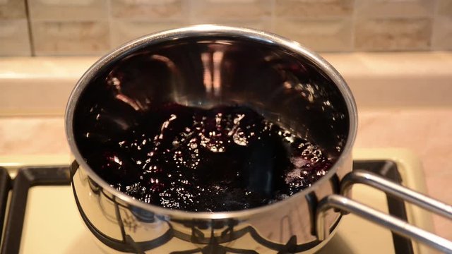 Making bluberry syrup. Baking cakes and confectionery. Cooking sugar syrup for using in bakery. The process of cooking macaroons.