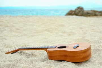 beautiful guitar on the sand by the Greek sea